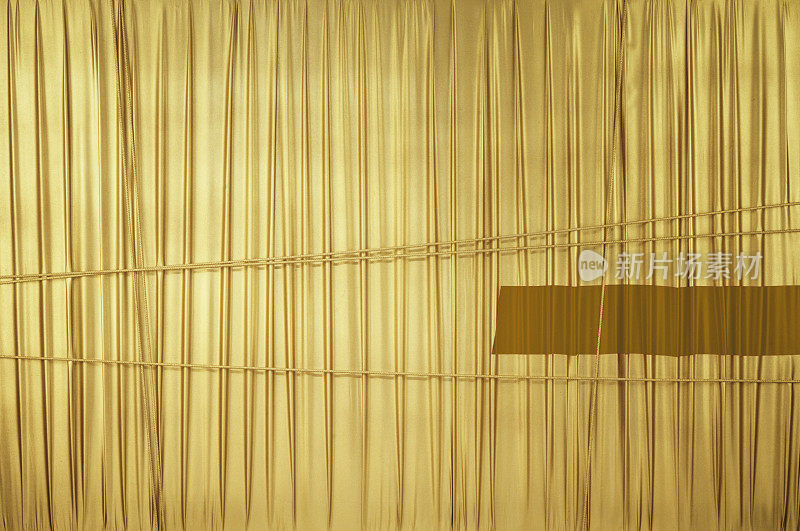 Wall wrapped in gold fabric
